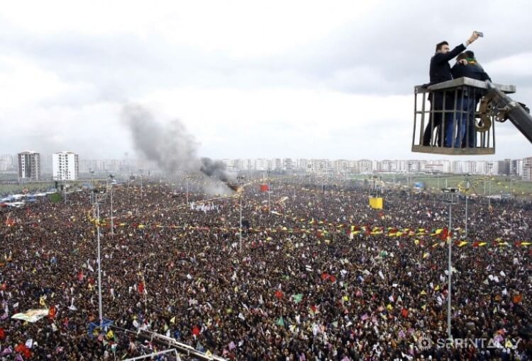 backdrop of tens of thousands of people