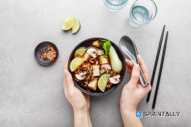 woman eating tofu asian vegetarian soup bowl